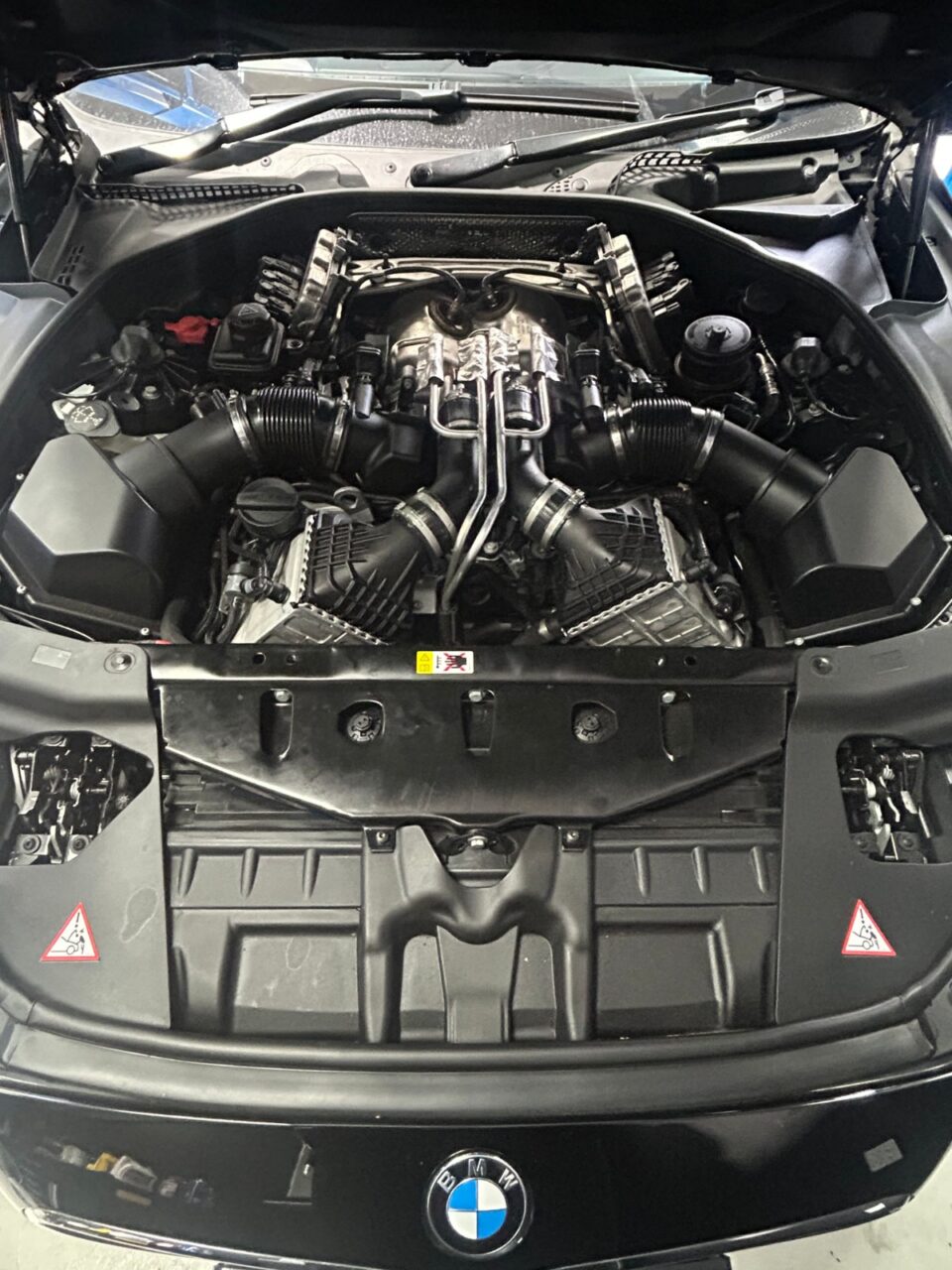 Euro MD - a BMW M engine bay opened up for servicing in Pukekohe
